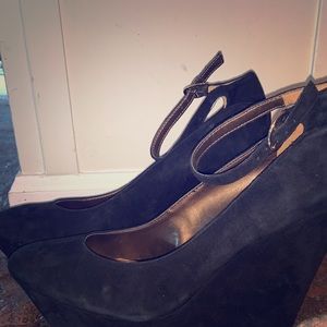 Black platform wedge with ankle strap.